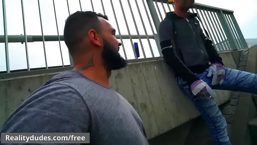 Raw Rivals Engage in Lewd Oral Face-Off, Exchanging Spit-Slicked Cock in Public Square -